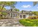 Beautiful home exterior with a three-car garage, a circular driveway, and lovely landscaping at 8440 Woburn Ct, Windermere, FL 34786