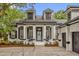 Charming front entrance with pillars, dormer windows, and a welcoming blue front door at 8440 Woburn Ct, Windermere, FL 34786
