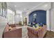 Beautiful living room with a blue accent wall, hardwood floors, and ample natural light at 8440 Woburn Ct, Windermere, FL 34786
