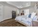 A roomy main bedroom showcasing dark wood floors and elegant, neutral decor at 8440 Woburn Ct, Windermere, FL 34786