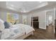 Bright main bedroom with tray ceiling, a four-poster bed, and lots of natural light at 8440 Woburn Ct, Windermere, FL 34786