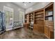 Inviting home office with built-in bookshelves and ample natural light at 8440 Woburn Ct, Windermere, FL 34786