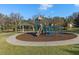 Community playground with modern equipment and a safe, soft surface, providing a fun and engaging space for children at 8440 Woburn Ct, Windermere, FL 34786