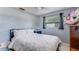 Cozy bedroom with a queen-size bed, a window, and a serene atmosphere at 8606 Lsu Ln, Orlando, FL 32817