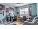 Bright bedroom with a soothing color palette, a comfortable seating area, and natural light at 8606 Lsu Ln, Orlando, FL 32817