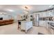 Open-concept kitchen with stainless steel appliances, a granite island, and seamless flow to living area at 8606 Lsu Ln, Orlando, FL 32817