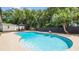 Backyard pool and patio area with outdoor seating, surrounded by lush landscaping and a privacy fence at 8606 Lsu Ln, Orlando, FL 32817