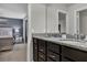 Bathroom featuring a double vanity with dark wood cabinets and granite countertops at 8814 Geneve Ct, Kissimmee, FL 34747