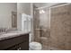 Bathroom boasts a tiled walk-in shower, granite countertop, and a stylish vanity with fixtures at 8814 Geneve Ct, Kissimmee, FL 34747