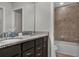 Bathroom boasts a double sink vanity with granite countertops and a tub-shower combo at 8814 Geneve Ct, Kissimmee, FL 34747