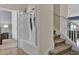 Inviting entryway featuring a built-in bench with storage and an umbrella rack near staircase at 8814 Geneve Ct, Kissimmee, FL 34747