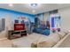 Comfortable game room with Superhero murals, large screen TV, and doorway to the bedroom at 8814 Geneve Ct, Kissimmee, FL 34747