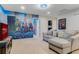 Spacious game room with superhero-themed murals and comfortable seating area at 8814 Geneve Ct, Kissimmee, FL 34747