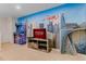 Avengers-themed game room with a large screen TV, arcade game, and city skyline mural at 8814 Geneve Ct, Kissimmee, FL 34747