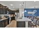 Bright kitchen featuring a granite island with breakfast bar and modern appliances at 8814 Geneve Ct, Kissimmee, FL 34747