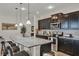Modern kitchen with granite countertops, stainless steel appliances, and breakfast bar seating at 8814 Geneve Ct, Kissimmee, FL 34747