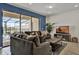 Cozy living room featuring a comfortable brown sofa and sliding glass doors to screened pool at 8814 Geneve Ct, Kissimmee, FL 34747