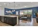 Open floorplan with kitchen island, dining area, and living room for seamless entertaining at 8814 Geneve Ct, Kissimmee, FL 34747