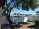 Large backyard features a sturdy white fence and mature shade tree at 9313 Pavillion Dr, Orlando, FL 32825