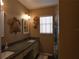 Neutral toned bathroom featuring granite countertops and nautical themed decorations at 9313 Pavillion Dr, Orlando, FL 32825