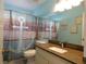 Bathroom featuring an anchor-themed shower curtain, a vanity with a granite countertop and a large mirror at 9313 Pavillion Dr, Orlando, FL 32825