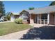 Charming single-story home with a well-manicured lawn and a brick-paved driveway at 9313 Pavillion Dr, Orlando, FL 32825
