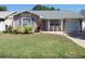 Charming single-story home with a well-manicured lawn, tiled walkway and attached one car garage at 9313 Pavillion Dr, Orlando, FL 32825