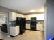 Clean kitchen features white cabinets, granite countertops, and stainless steel appliances at 9313 Pavillion Dr, Orlando, FL 32825
