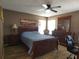 Main bedroom featuring a ceiling fan, natural light and wood-look floors at 9313 Pavillion Dr, Orlando, FL 32825
