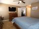 Main bedroom featuring a ceiling fan, desk, closet and wood-look floors at 9313 Pavillion Dr, Orlando, FL 32825