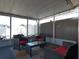 Sunroom area with wicker furniture, red cushions and glass coffee table at 9313 Pavillion Dr, Orlando, FL 32825