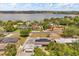 An aerial view showing the property near a picturesque lake, landscaped homes, and mature trees at 932 Campbell Ave, Lake Wales, FL 33853