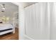 Bathroom with bright white curtain and adjacent main bedroom at 932 Campbell Ave, Lake Wales, FL 33853
