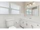 Bright bathroom featuring tile surround, white cabinets, and a decorative mirror at 932 Campbell Ave, Lake Wales, FL 33853