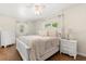 Comfortable bedroom with hardwood floors, a ceiling fan, and an elegant bed frame at 932 Campbell Ave, Lake Wales, FL 33853