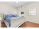 Bedroom featuring hardwood floors, ceiling fan, and stylish white bed frame at 932 Campbell Ave, Lake Wales, FL 33853