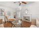 Bright living room boasts a decorative fireplace, wood floors, ceiling fan, and neutral decor at 932 Campbell Ave, Lake Wales, FL 33853