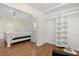 Main bedroom adjacent to a walk-in closet, hardwood floors, and ceiling fan at 932 Campbell Ave, Lake Wales, FL 33853