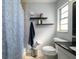 Cozy bathroom featuring floating shelves and a vanity with black granite countertop at 941 Barbados Ave, Orlando, FL 32825