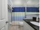 Bright bathroom featuring a vanity with granite countertop and a shower with a colorful curtain at 941 Barbados Ave, Orlando, FL 32825