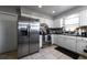 Bright kitchen with stainless steel refrigerator, white cabinets, mosaic backsplash and tile flooring at 941 Barbados Ave, Orlando, FL 32825