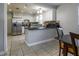 Well-appointed kitchen features white cabinetry, tile backsplash, stainless steel appliances, and a breakfast bar at 941 Barbados Ave, Orlando, FL 32825