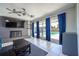 Living room boasts tile flooring, ceiling fans, a brick fireplace, and access to the backyard pool area at 941 Barbados Ave, Orlando, FL 32825