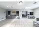 Open-concept living room with tile flooring, built-in shelving, and a view of the dining area at 941 Barbados Ave, Orlando, FL 32825