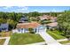 Aerial view of a house with mature landscaping, long driveway and well-kept lawn at 996 Big Oaks Dr, Oviedo, FL 32765