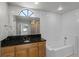 Stylish bathroom with a granite vanity, a tub with a tiled shower and a clear glass door at 996 Big Oaks Dr, Oviedo, FL 32765