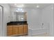 Elegant bathroom with a large mirror, granite countertop, and tiled tub/shower combination at 996 Big Oaks Dr, Oviedo, FL 32765