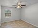 Clean bedroom featuring tile floors, a ceiling fan, and a view of the backyard at 996 Big Oaks Dr, Oviedo, FL 32765