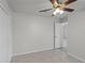 Neutral bedroom featuring tile floors, closet, ceiling fan, and doorway view to another room at 996 Big Oaks Dr, Oviedo, FL 32765