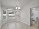 Bright dining area featuring tile floors, a chandelier, and view of the pool through bay windows at 996 Big Oaks Dr, Oviedo, FL 32765